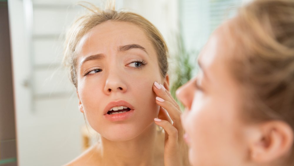 Woman looking in mirror