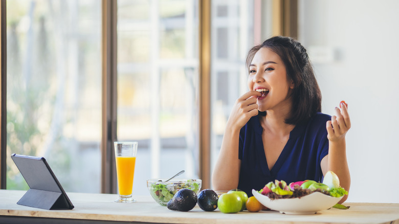 Happy vegan eating healthy meal