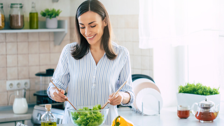 A person preparing a salad