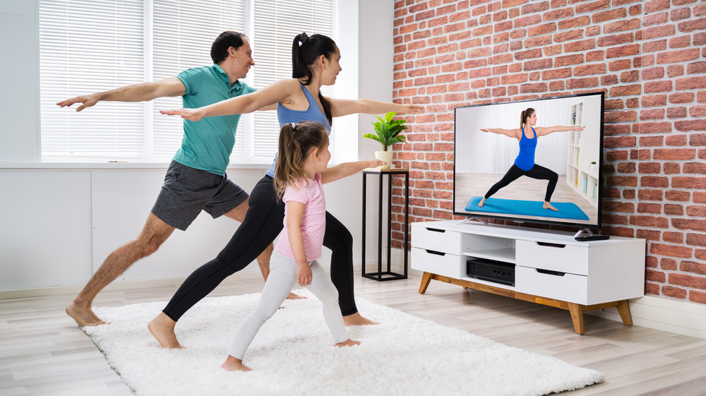A family practicing yoga barefoot at home 