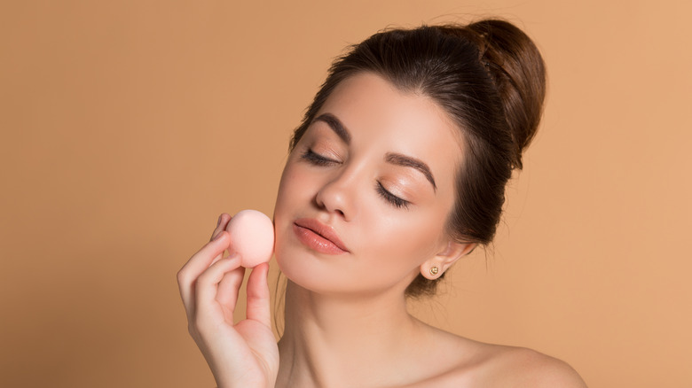 woman using a blending sponge 