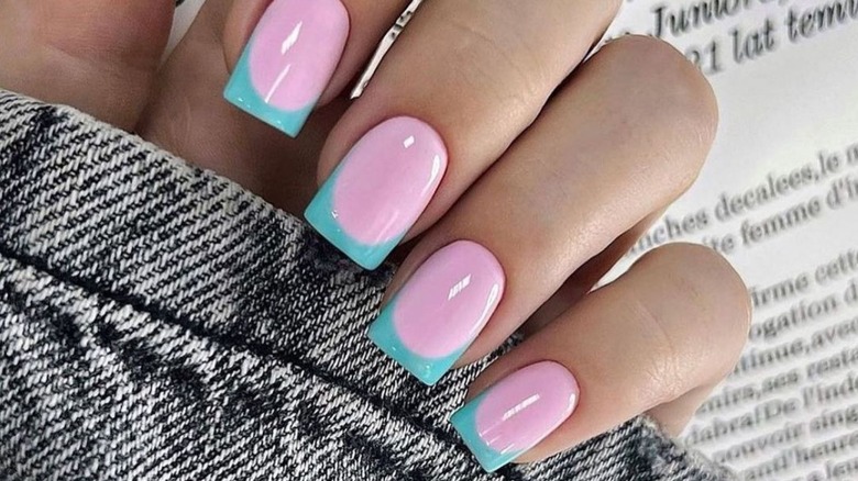 A pink and blue French tip manicure
