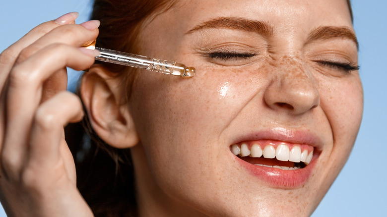 Woman using facial cleansing oil