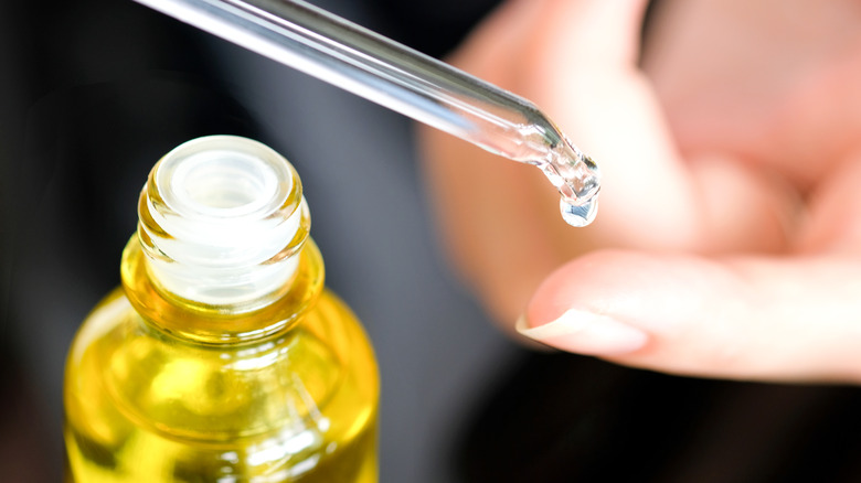 Woman with an oil dropper