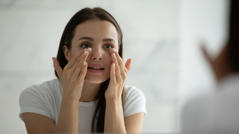 Woman smoothing skin