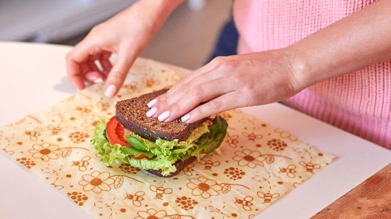 Woman wrapping a sandwich in beeswax wrap