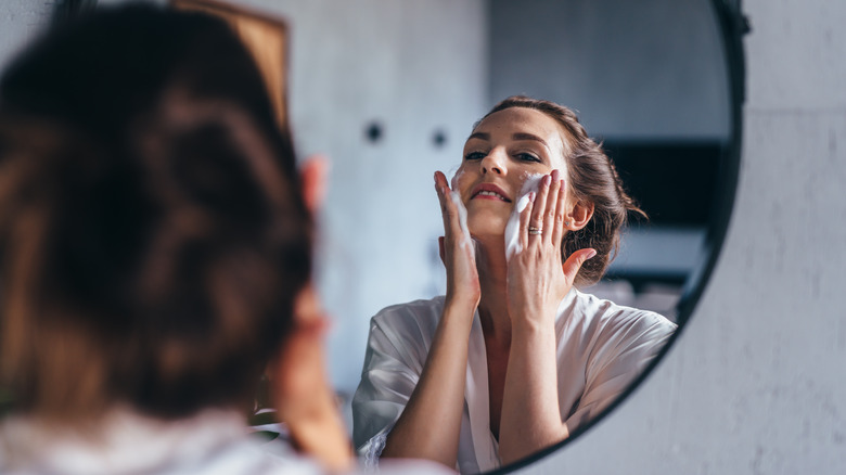 A woman cleansing her face