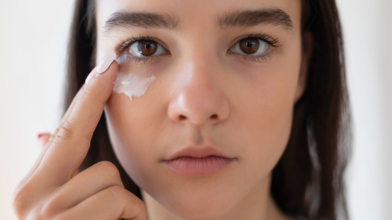 Woman applying eye cream