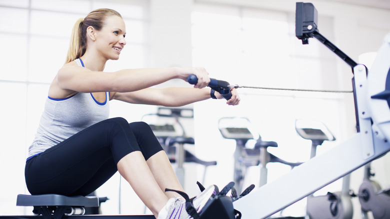 Woman rowing on rowing machine