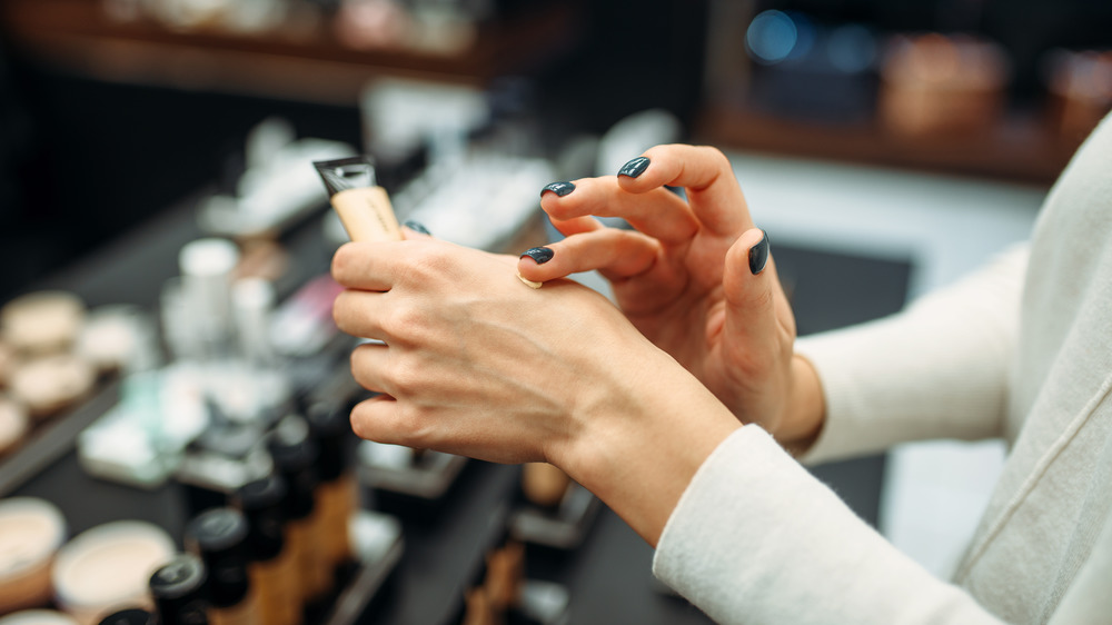 Woman testing makeup in store