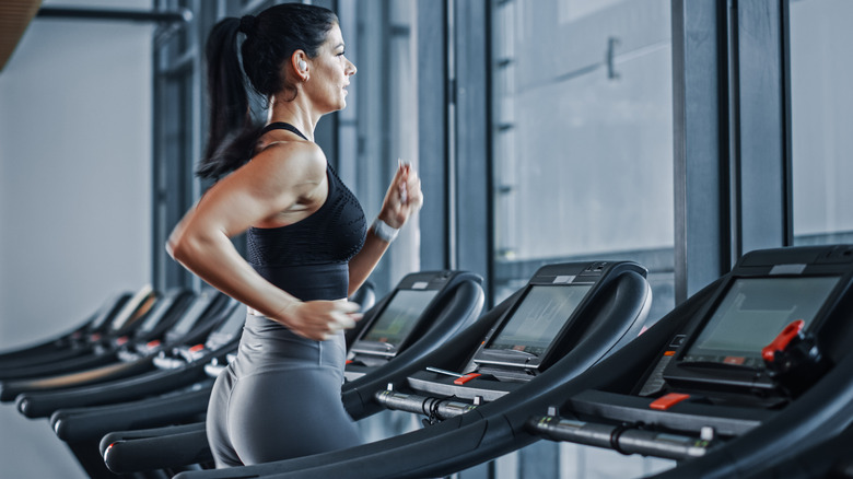 Woman using headphones on the treadmill