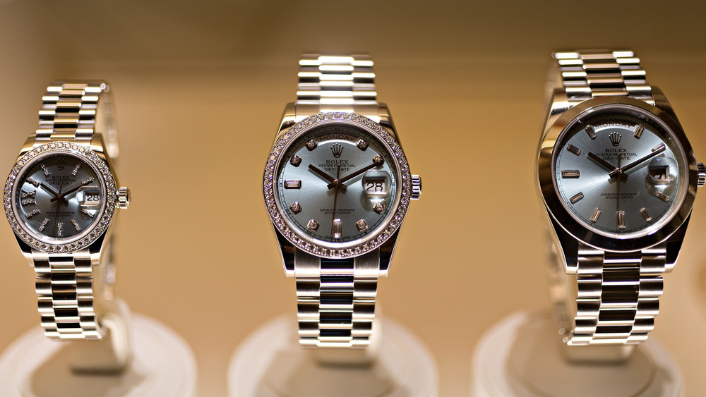 Three Rolex watches on display