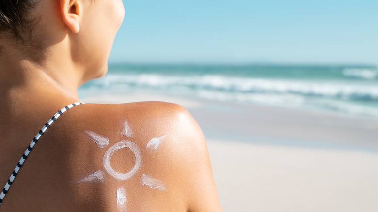 Woman with sunscreen on shoulder