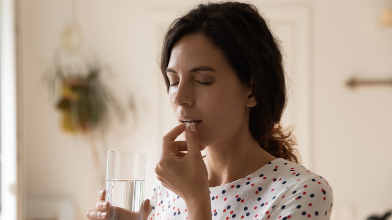 woman taking medicine