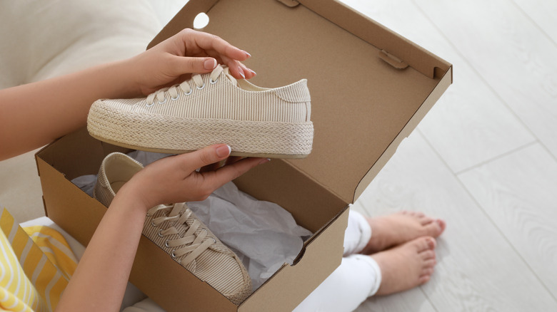 Woman opening a shoebox