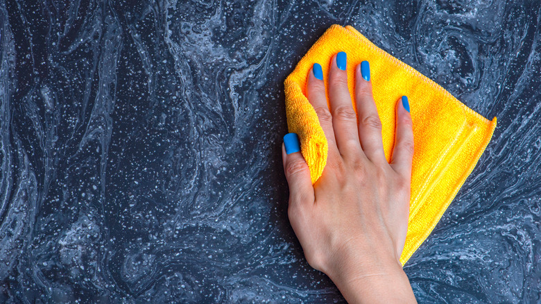 Person cleaning marble counter 