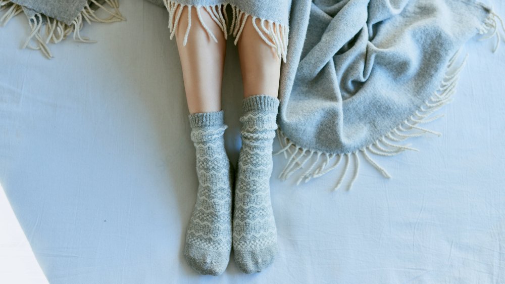 blue socks covered blue blanket blue sheets