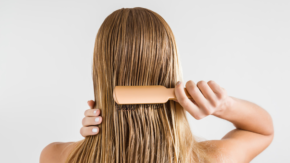 Woman brushing her hair when it's wet