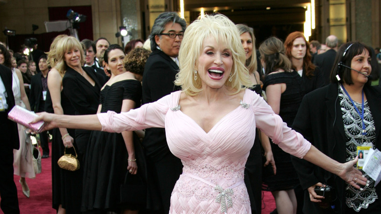 Dolly Parton in a baby pink gown on the red carpet