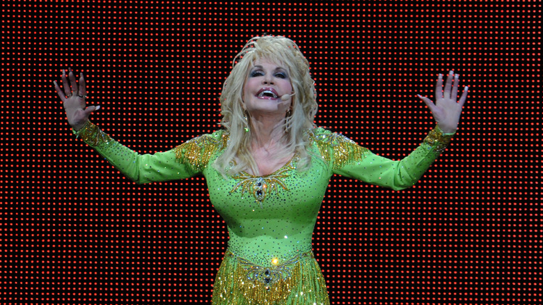Dolly Parton in a neon green embellished outfit with full sleeves