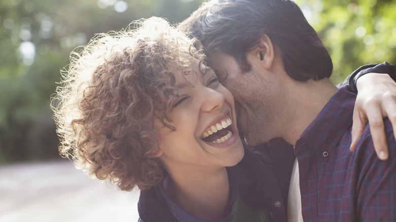 Partners hugging and laughing