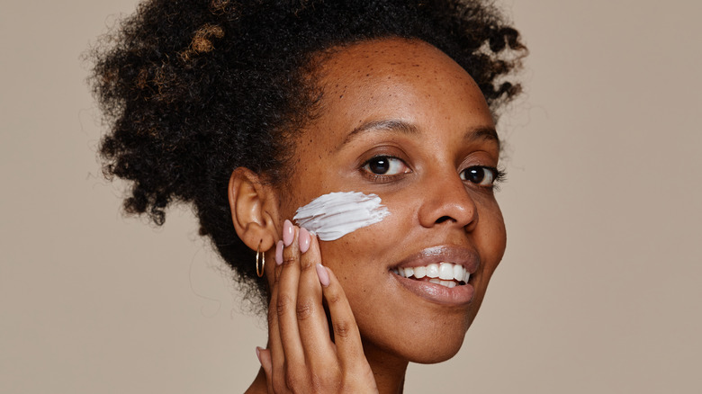 woman applying face cream