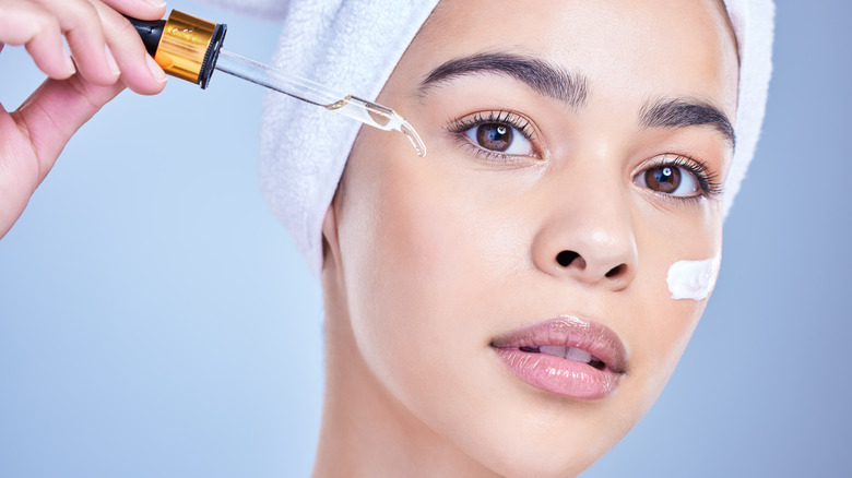 Woman putting on face cream