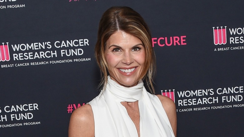 Lori Loughlin smiling in a white dress