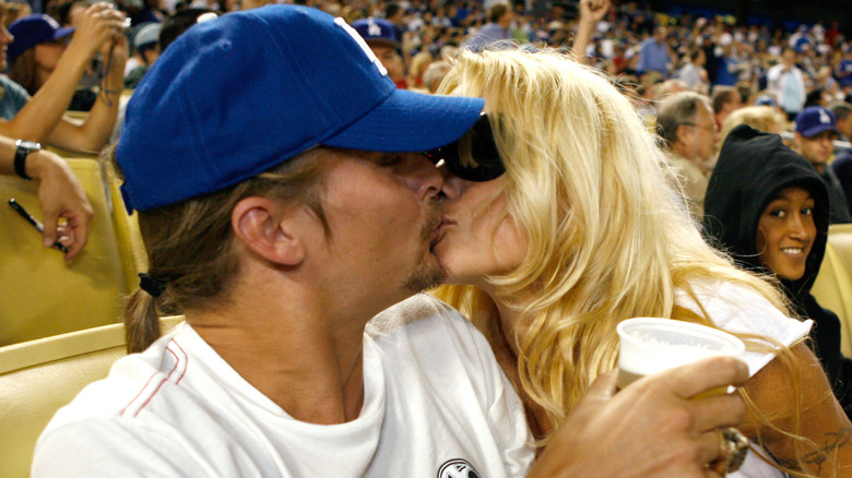 Kid Rock and Pamela Anderson kissing at a baseball game