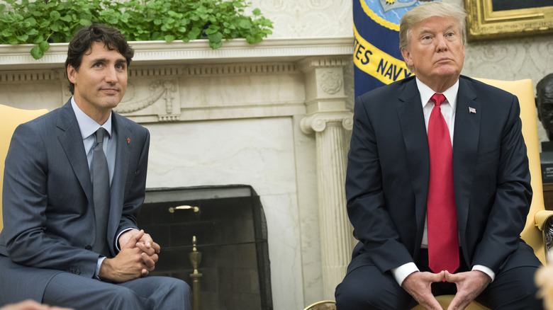 Justin Trudeau sitting with Donald Trump