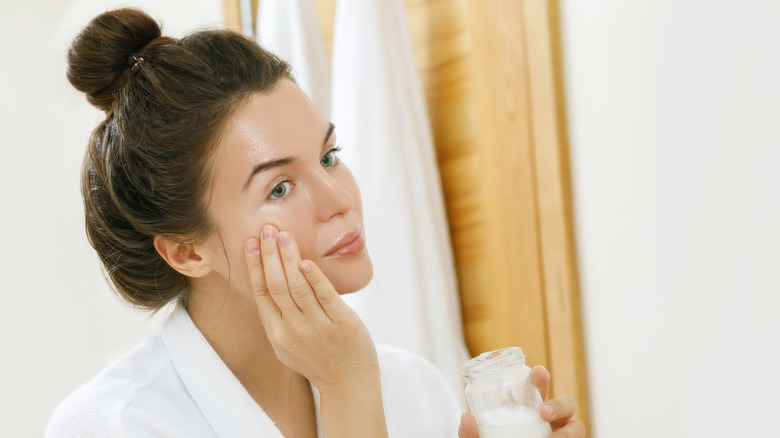 Woman applying coconut oil