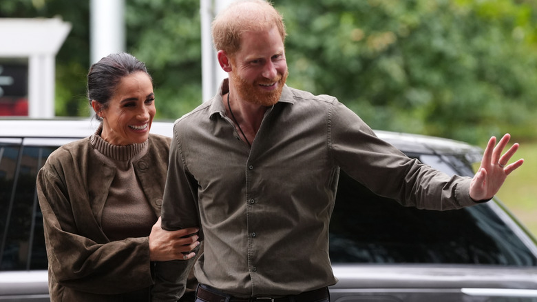 Prince Harry and Meghan Markle greeting members of the public in matching olive green looks