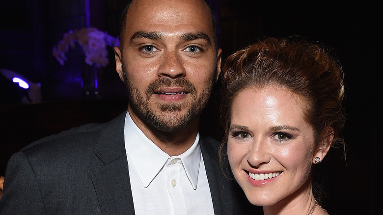Jesse Williams and Sarah Drew smile together at a party
