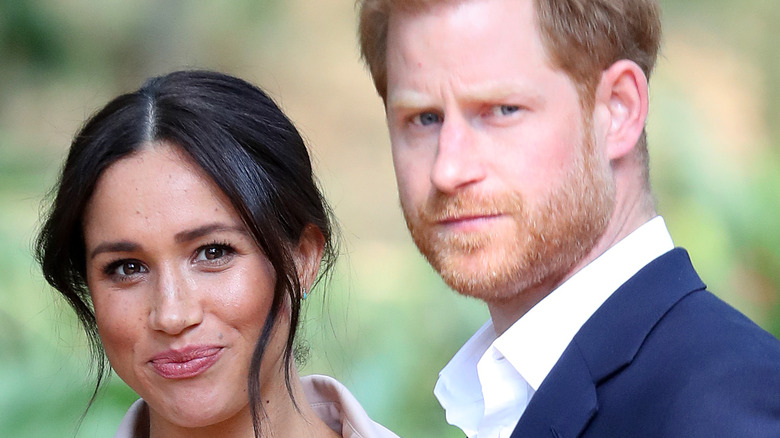 Meghan Markle and Prince Harry staring at paparazzi 