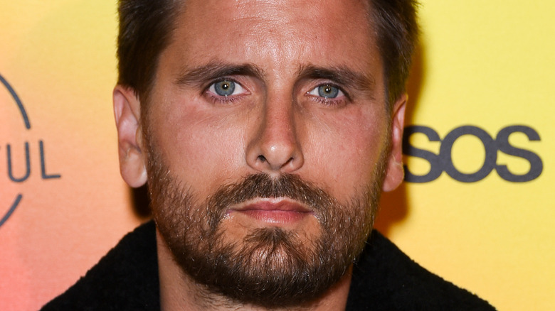 Scott Disick posing at an event. 