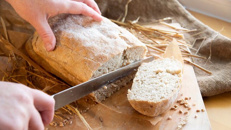 Person slicing bread