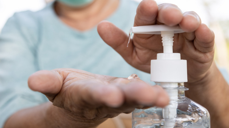 Person squirting hand sanitizer