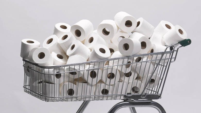 toilet paper piled into a shopping cart