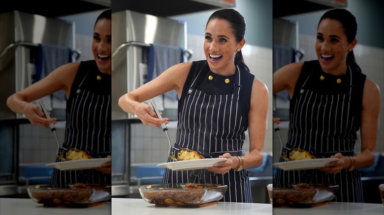 Meghan Markle wearing apron while serving lunch