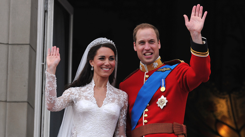 William, Prince of Wales and Catherine, Princess of Wales waving from the Buckingham Palace balcony on their wedding day