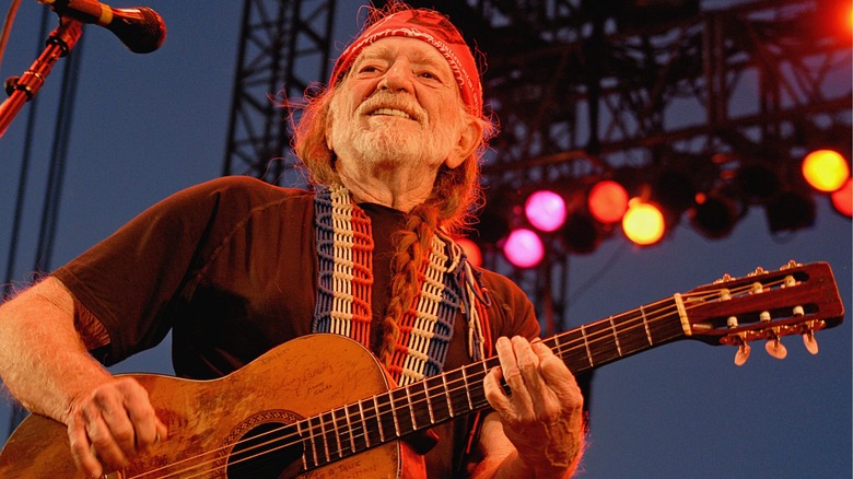 Willie Nelson performing and smiling