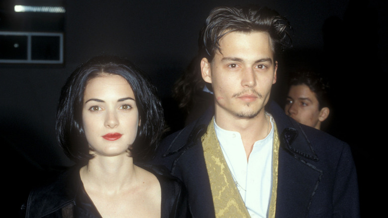 Winona Ryder has a short, black bob next to Johnny Depp
