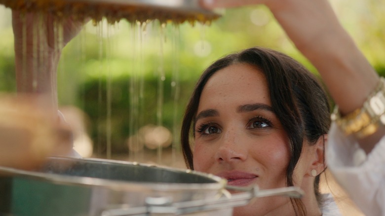 A glimpse of her Cartier watch while bee keeping in "With Love, Meghan"