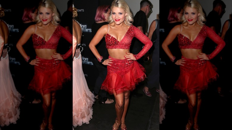 Witney Carson poses in a red outfit