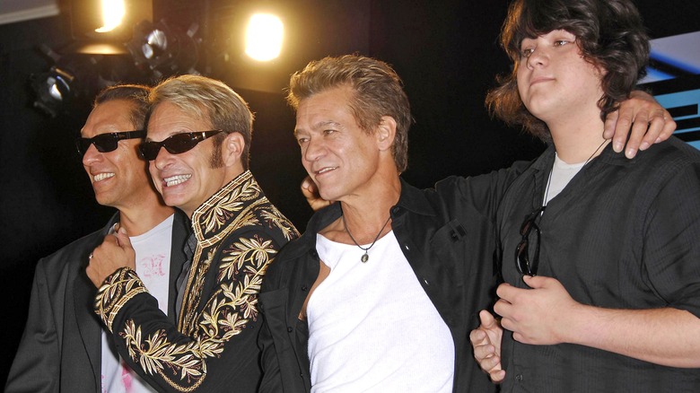 Alex Van Halen, David Lee Roth, Eddie Van Halen, and a teenage Wolfgang Van Halen posing
