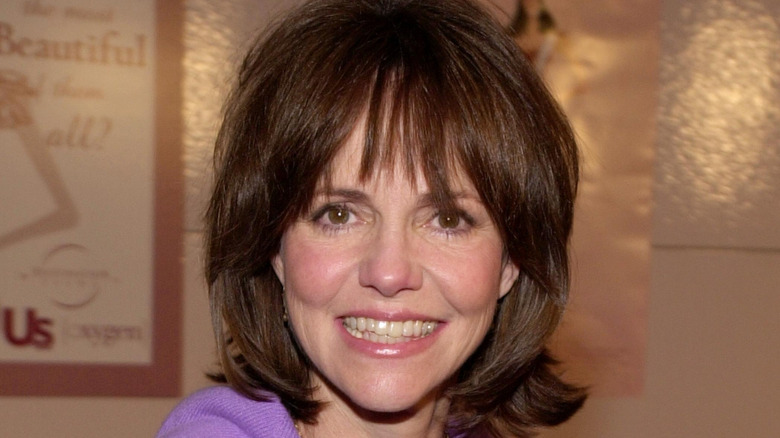 Sally Field smiling in a purple top