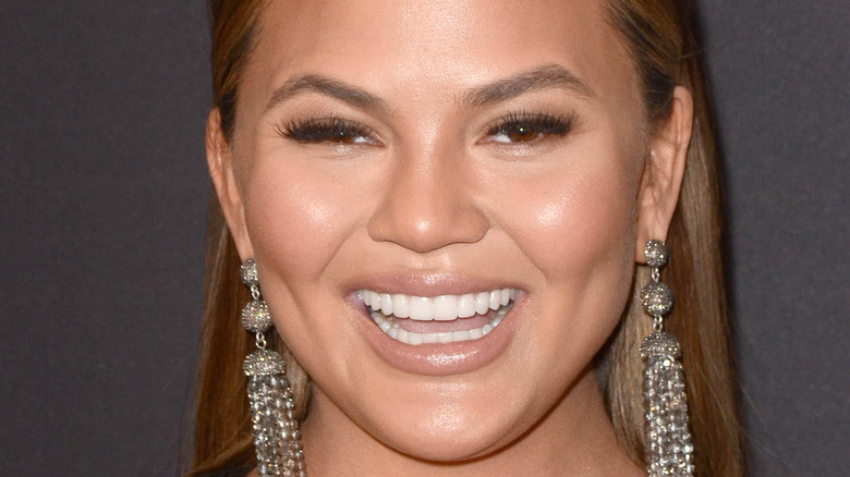 Chrissy Teigen happy at an event