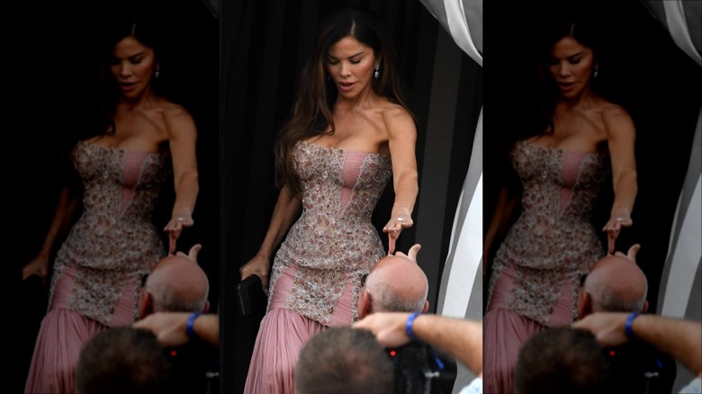 Lauren Sánchez Bezos taking Jeff Bezos' hand