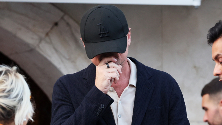 Leonardo DiCaprio covering his face