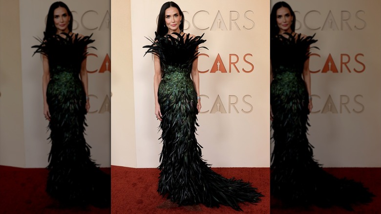 Demi Moore posing in feathers on the red carpet